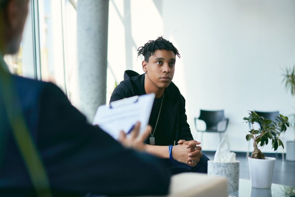 A member of staff meeting with a young person